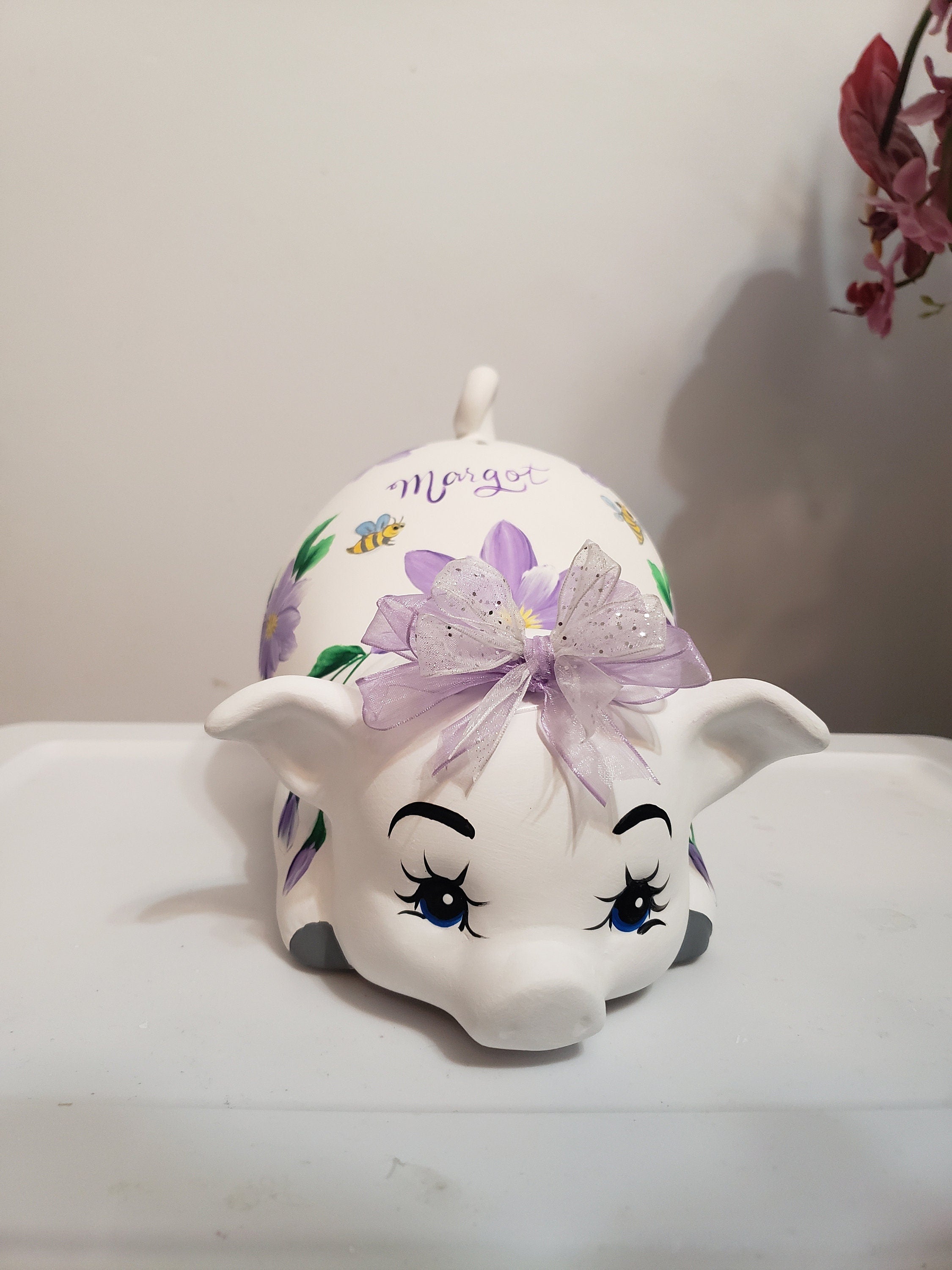 Large piggy bank with purple flowers and bees