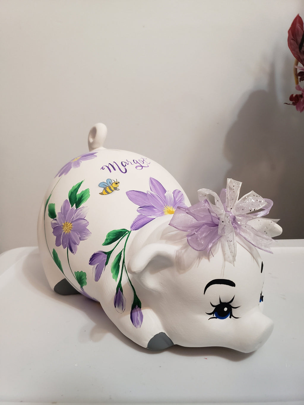Large piggy bank with purple flowers and bees