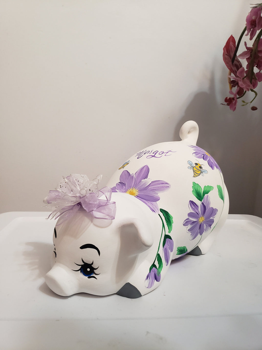 Large piggy bank with purple flowers and bees