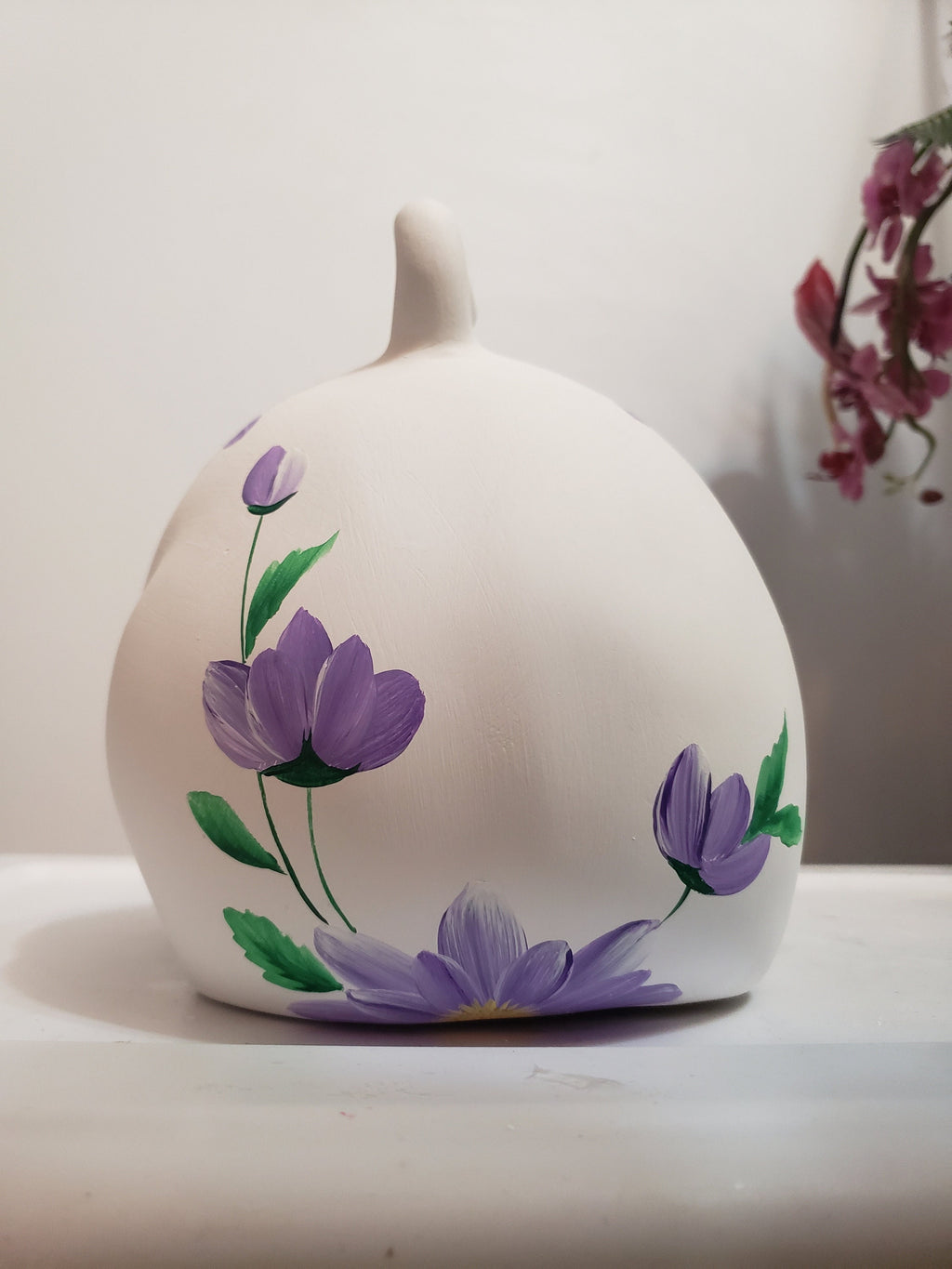 Large piggy bank with purple flowers and bees