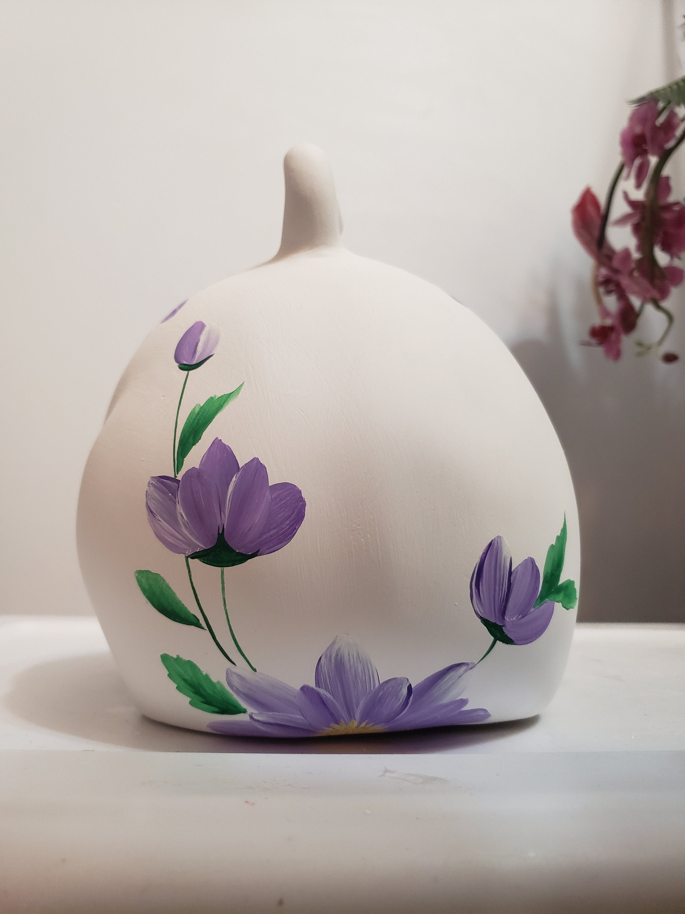 Large piggy bank with purple flowers and bees